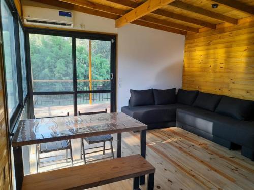 a living room with a couch and a table at Muelle Delta Arias - EN TIGRE ISLA - in Tigre