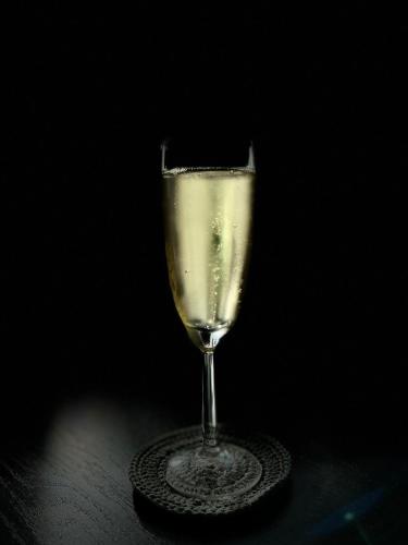 a glass of white wine sitting on a table at Casa Ferreira Cumbuco in Caucaia