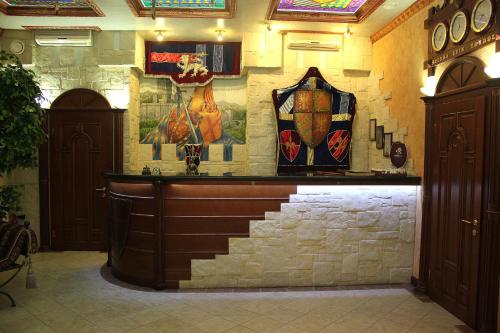 a bar in a building with paintings on the wall at Kamelot in Kyiv