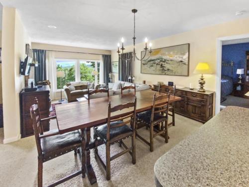 a dining room and living room with a table and chairs at Sugarbush Summit Condo in Warren