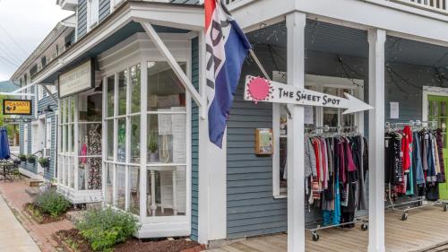 a shop with a flag in front of it at Sugarbush Summit Condo in Warren