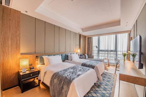 Postel nebo postele na pokoji v ubytování Ascott M-City Foshan - Free Shuttle Bus to Canton Fair