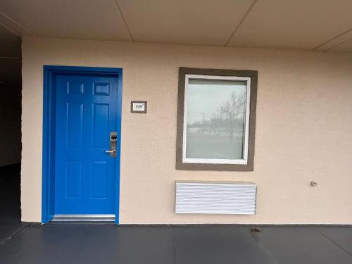 a building with a blue door and a window at Super 8 by Wyndham Paducah I-24 Exit 4 in Paducah