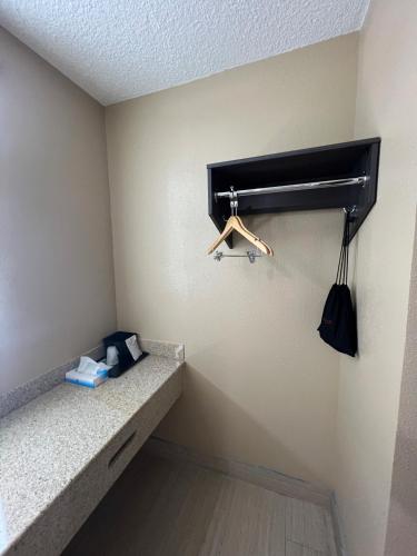 a walk in closet with a hanger in a room at Super 8 by Wyndham Paducah I-24 Exit 4 in Paducah
