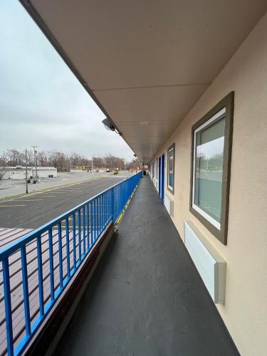 a corridor of a building with a blue railing at Super 8 by Wyndham Paducah I-24 Exit 4 in Paducah