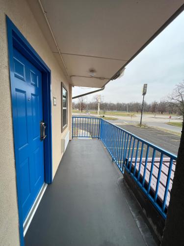 a blue door on a school building with a sidewalk at Super 8 by Wyndham Paducah I-24 Exit 4 in Paducah