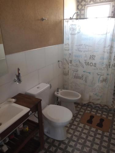 a bathroom with a toilet and a sink at Balcon al Valle Grande, San Rafael Mendoza in Valle Grande