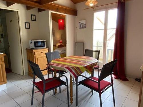 une salle à manger avec une table et des chaises dans une cuisine dans l'établissement Appartement 2 pièces proche plage à Dolus d'Oléron – 4 couchages, balcon, parking, local vélo - FR-1-246A-151, à Dolus-d'Oléron