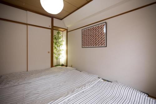a bedroom with a bed and a window at Amber Iidabashi - Vacation STAY 90505v in Tokyo