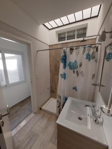 a bathroom with a sink and a shower at Casa en Mar del Plata in Mar del Plata
