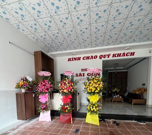a lobby with flowers and signs on the ceiling at Sai Gon Motel in Da Nang
