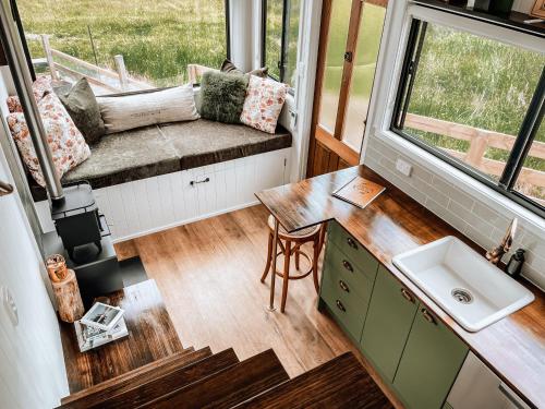 a tiny house with a sink and a bench at Shepherd & Sprout Boutique Tiny House - Cradle Country in Wilmot