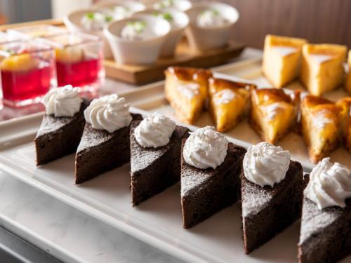 a plate of chocolate cakes and pastries on a table at ANA Crowne Plaza Akita by IHG in Akita