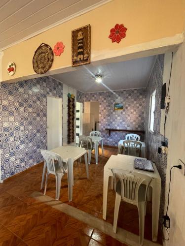 a room with tables and chairs in a room at Casa Dona Vilma in Barreirinhas