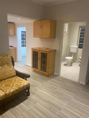 a living room with a couch and a toilet at Bedford Way cottages in Bedford