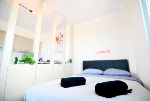 two black bags sitting on top of a bed at Amazing seaview studio with pool-steps away beach in Áyios Yeórgios