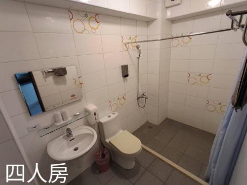a bathroom with a toilet and a sink at Especially chef's home B&B in Hualien City