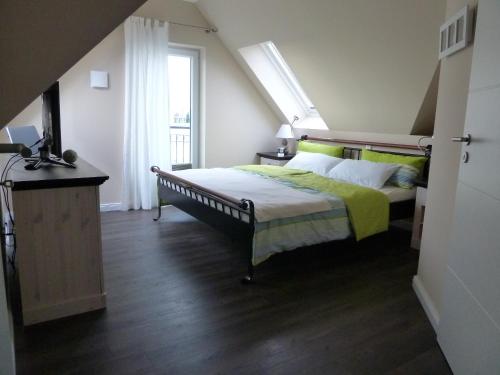 a bedroom with a bed with yellow sheets and a window at Fewo Baltic Dreams in Börgerende-Rethwisch