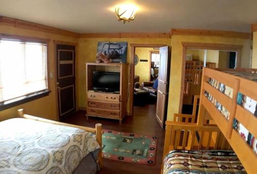 a bedroom with a bed and a television in a room at Snow Bear Breckenridge 4 in Taos Ski Valley