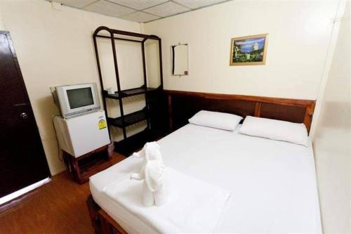 En eller flere senge i et værelse på SSP Bungalow