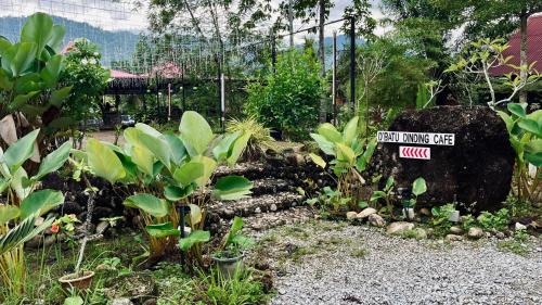 a garden with a sign that reads first monkey cafe at Sahom Valley Resort - Agro & Eco Park in Kampar