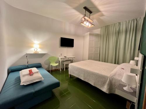 a bedroom with a bed and a desk and a tv at Levante96 in Bologna