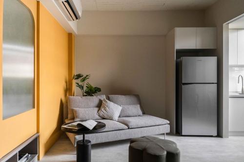 a living room with a couch and a refrigerator at Lin Apartments by Olala Homes in Taipei