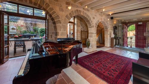 a living room with a piano in a building at Kókkini Porta Rossa in Rhodes Town