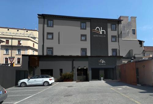 a car parked in a parking lot in front of a building at Ah Villaglori Boutique Apartments in Brescia