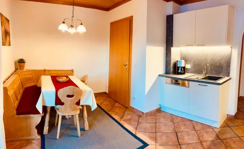 a kitchen with a table and a small table and chairs at Haus Plattenkar in Obertauern