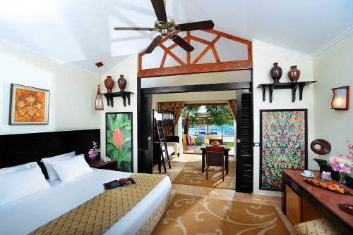 a bedroom with a bed and a ceiling fan at Neverland City Hurghada - Pickalbatros in Hurghada