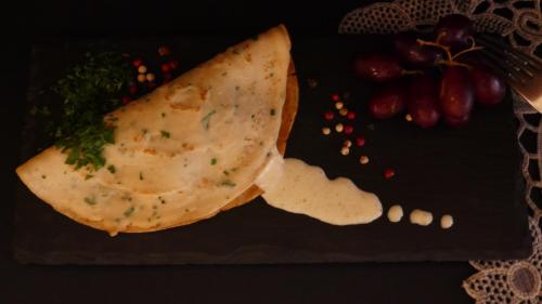a plate of food with a tortilla and grapes at Kókkini Porta Rossa in Rhodes Town