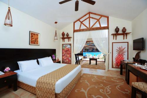 a bedroom with a large bed and a living room at Neverland City Hurghada - Pickalbatros in Hurghada