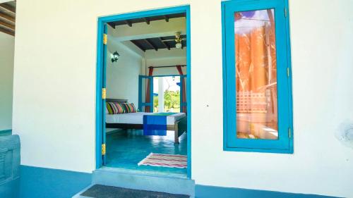 a blue door to a room with a bedroom at Seth Villa by Magampura Resorts in Tangalle