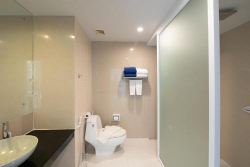 a bathroom with a toilet and a sink at Arinara Beach Resort Phuket - SHA Extra Plus in Bang Tao Beach