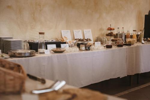 a long white table with food on it at Agriturismo Tenuta La Romana in Nizza Monferrato
