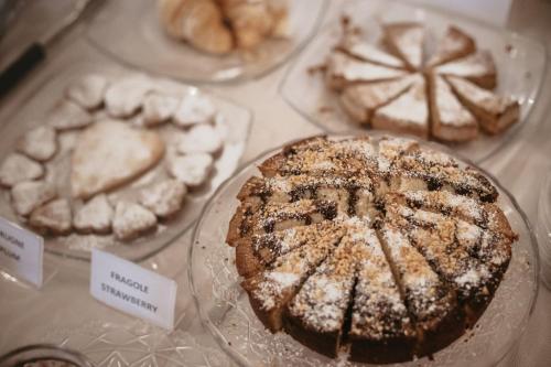 a display of different types of pastries on plates at Agriturismo Tenuta La Romana in Nizza Monferrato