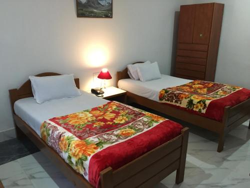 Postel nebo postele na pokoji v ubytování HOTEL BODHGAYA INN