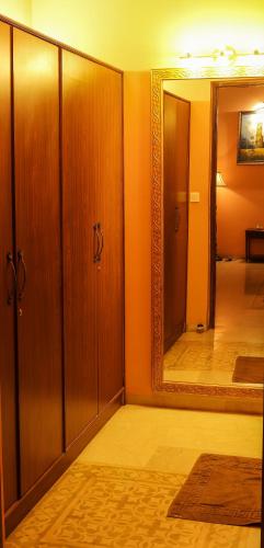 a room with a mirror and some wooden cabinets at Surya Kiran Heritage Hotel in Panaji