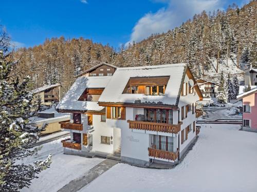 a house in the snow with a mountain at Rosatsch 14 in Surlej