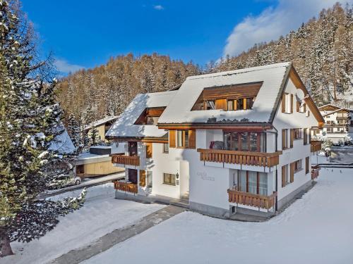 a house in the snow with a mountain at Rosatsch 13 in Surlej