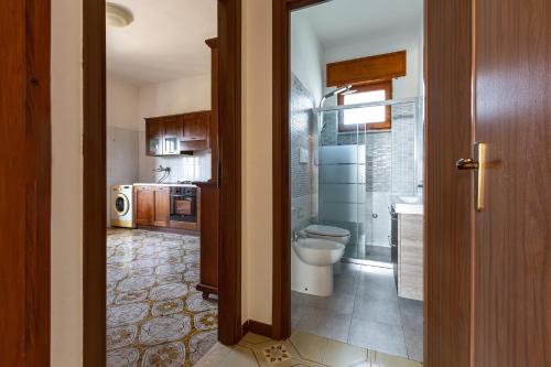 a bathroom with a sink and a toilet in a room at Villa Santina by BarbarHouse in Torre Colimena
