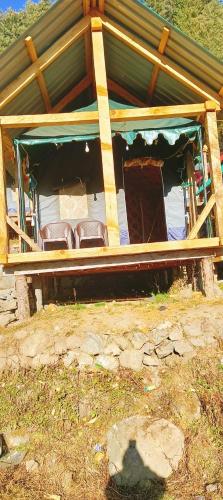 a house with a porch with chairs in it at olive garden kutla camping in Tosh