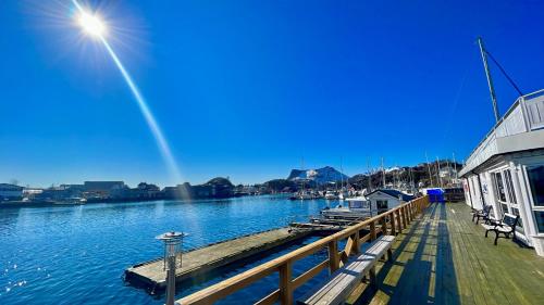 a wooden dock with a docking station on the water at Lofoten Rorbuer in Svolvær