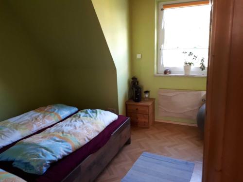 a small bedroom with a bed and a window at Ferienwohnung Krieger in Thurnau