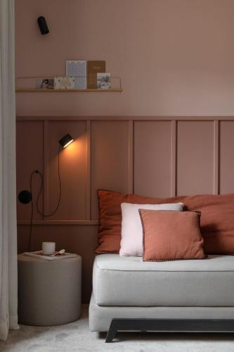 a bedroom with a bed and a table with a lamp at Hôtel Le Prieuré in Paray-le-Monial