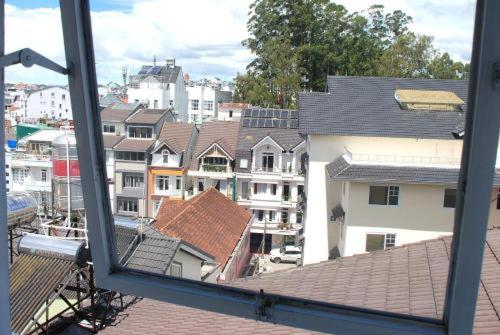 a view from a window of a city with buildings at New Sleep in Dalat Hostel in Da Lat