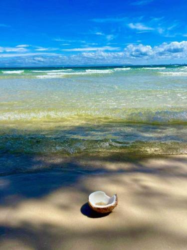 a hat sitting on a beach near the ocean at Bunnan Bungalows in Koh Rong Island