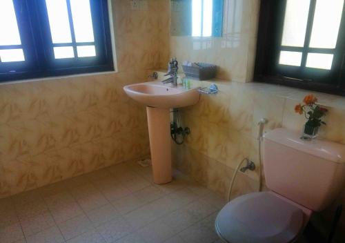 a bathroom with a sink and a toilet at Sky Valley in Kandy