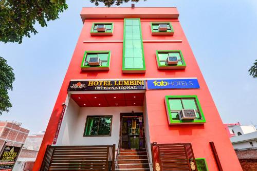 czerwony budynek z napisem w obiekcie FabHotel Lumbini International w mieście Waranasi